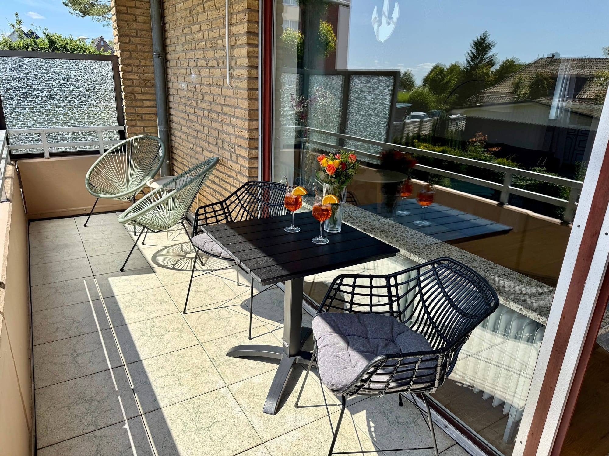 Covered balcony with table, chairs and lounge chair