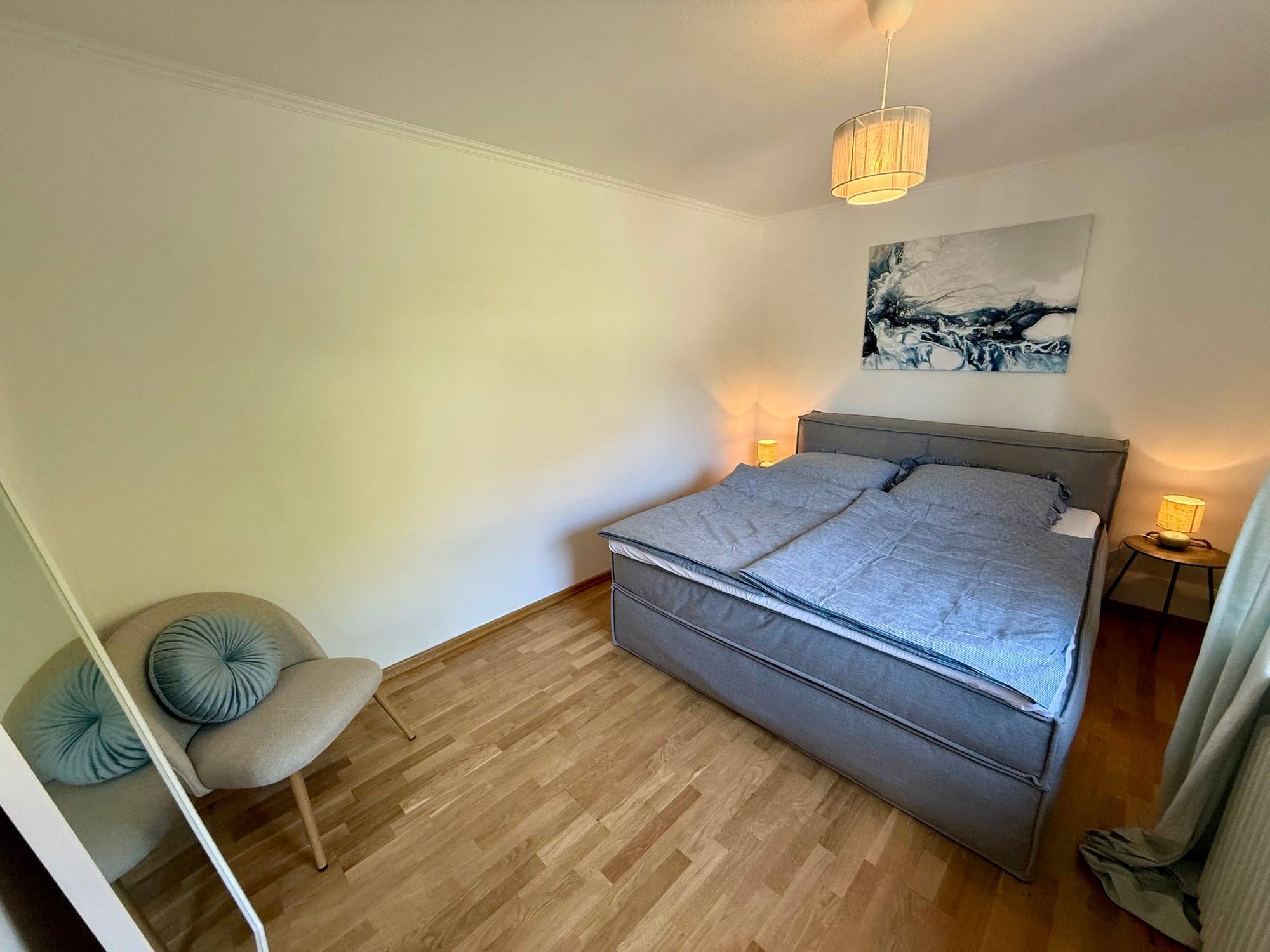 Bedroom with double bed and armchair
