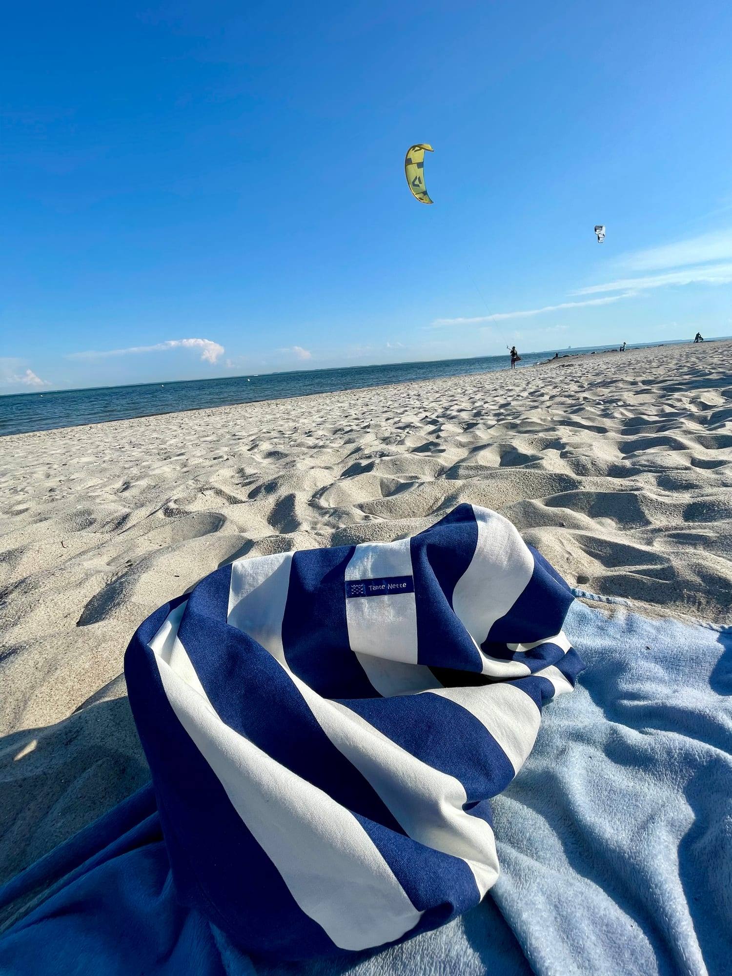 Striped towel on the sand at the Baltic Sea beach